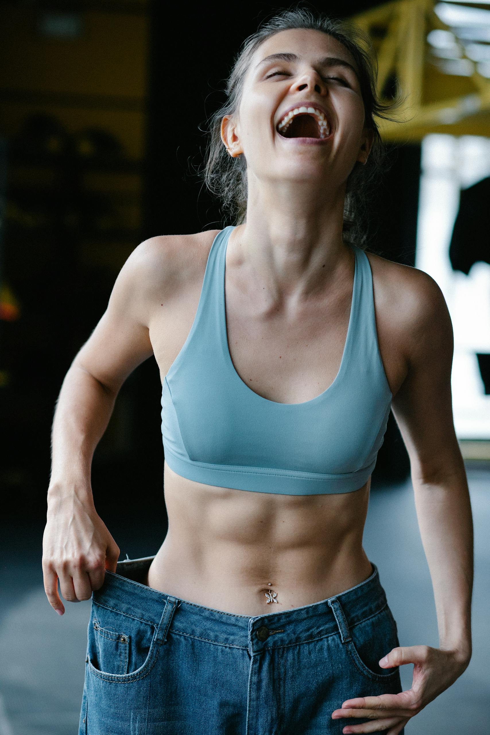 Smiling Fit Woman Wearing Too Big Jeans